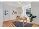Bright office space with hardwood floors, complemented by natural light, a modern desk, and a lush green plant at 729 E 10Th Ave, Denver, CO 80203