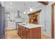 Bright kitchen features a large island, stainless steel appliances, and white brick accent wall at 729 E 10Th Ave, Denver, CO 80203