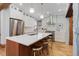 Modern kitchen boasts an island with seating, stainless appliances, and brick accent wall at 729 E 10Th Ave, Denver, CO 80203
