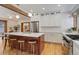 Modern kitchen features a large island with seating, white cabinets, stainless steel appliances, and hardwood floors at 729 E 10Th Ave, Denver, CO 80203