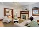 Cozy living room featuring a decorative fireplace, hardwood floors, and comfortable seating for relaxation at 729 E 10Th Ave, Denver, CO 80203