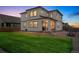 Lush backyard with a well-maintained lawn, covered patio, and modern grill, ideal for outdoor entertaining at 13329 Newport Cir, Thornton, CO 80602