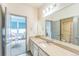 Bright bathroom with granite countertop, large mirror, and adjacent rooms at 13329 Newport Cir, Thornton, CO 80602