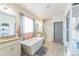 Bright bathroom with a large soaking tub, separate shower, and double vanity sinks at 13329 Newport Cir, Thornton, CO 80602