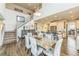Open floor plan featuring a dining area with hardwood floors and access to the kitchen and staircase at 13329 Newport Cir, Thornton, CO 80602