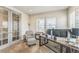 A dedicated home office with glass french doors, a patterned chair, and a large desk for remote work at 13329 Newport Cir, Thornton, CO 80602