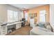 Bright office space with custom built in desk, chair and comfy seating area near sun-filled windows at 13329 Newport Cir, Thornton, CO 80602