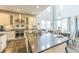 Bright, modern kitchen with a large island featuring bar seating and stainless steel appliances at 13329 Newport Cir, Thornton, CO 80602
