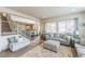View of a modern living room with stairs to the left and eat-in kitchen in the background at 13329 Newport Cir, Thornton, CO 80602