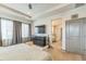 Spacious primary bedroom showcasing a TV, sitting area, and access to an en-suite bathroom for added convenience at 13329 Newport Cir, Thornton, CO 80602