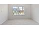 Bright bedroom with new carpet and a large window offering neighborhood views at 9100 E Girard Ave # 7, Denver, CO 80231