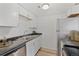 Functional kitchen features clean white cabinets, stainless steel appliances and wood-look floors at 9100 E Girard Ave # 7, Denver, CO 80231