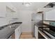 Efficient kitchen featuring stainless steel appliances, and white cabinetry at 9100 E Girard Ave # 7, Denver, CO 80231