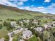 Panoramic aerial view showcasing the neighborhood with lush green spaces and mountain views at 8 Mountain Willow Dr, Littleton, CO 80127