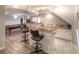 Finished basement with a wet bar, barstool seating, and hardwood style floors at 8 Mountain Willow Dr, Littleton, CO 80127