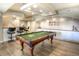 Basement featuring a pool table, bar area, and ample storage space with a neutral color scheme at 8 Mountain Willow Dr, Littleton, CO 80127