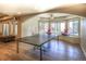 Finished basement has a ping pong table, an overhead ceiling fan, and several windows at 8 Mountain Willow Dr, Littleton, CO 80127