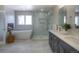 Bright bathroom featuring a double sink vanity, soaking tub, glass enclosed shower, and stylish contemporary finishes at 8 Mountain Willow Dr, Littleton, CO 80127