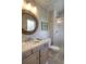 Charming bathroom featuring a marble countertop sink, a framed mirror, and a glass-enclosed shower, combining style and functionality at 8 Mountain Willow Dr, Littleton, CO 80127