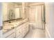 Well lit bathroom with a double sink vanity and a shower and tub combination at 8 Mountain Willow Dr, Littleton, CO 80127