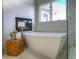 This spa bathroom features a free standing soaking tub and a walk-in glass shower with elegant, modern fixtures at 8 Mountain Willow Dr, Littleton, CO 80127