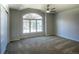 Empty bedroom features plush carpeting, neutral walls, and a large window offering bright, natural light at 8 Mountain Willow Dr, Littleton, CO 80127