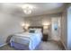 Cozy bedroom features soft lighting, a comfortable bed, and an ensuite bathroom for ultimate convenience and privacy at 8 Mountain Willow Dr, Littleton, CO 80127