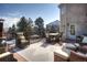 Relaxing outdoor deck with wicker furniture, a dining set, and views of the yard and neighborhood at 8 Mountain Willow Dr, Littleton, CO 80127