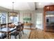 Bright dining room with hardwood floors, large windows providing natural light, and stylish light fixture above a wooden table at 8 Mountain Willow Dr, Littleton, CO 80127