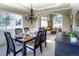 Formal dining room with a chandelier, large windows, and an archway to the living space at 8 Mountain Willow Dr, Littleton, CO 80127
