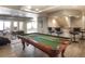 Spacious game room with a pool table, bar, and recessed lighting in basement at 8 Mountain Willow Dr, Littleton, CO 80127