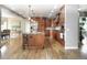 Well-lit kitchen with a large island, modern appliances, ample cabinet space, and hardwood floors throughout at 8 Mountain Willow Dr, Littleton, CO 80127