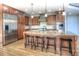 Spacious kitchen with wooden cabinets, stainless steel appliances, granite countertops, and an island with barstool seating at 8 Mountain Willow Dr, Littleton, CO 80127