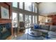 Cozy living room with a fireplace, large windows, and a comfortable seating area at 8 Mountain Willow Dr, Littleton, CO 80127