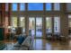 Bright living room featuring large windows, a comfortable sofa, and hardwood flooring at 8 Mountain Willow Dr, Littleton, CO 80127
