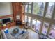 Bright living room featuring a fireplace, soaring windows, and access to a deck at 8 Mountain Willow Dr, Littleton, CO 80127