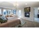 This luxurious main bedroom boasts generous windows, an inviting fireplace, and access to a private outdoor balcony at 8 Mountain Willow Dr, Littleton, CO 80127