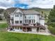 Spacious home featuring a large deck with seating and a walkout basement at 8 Mountain Willow Dr, Littleton, CO 80127