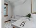 Bright bathroom with white tile, contrasting black accents, and a window allowing natural light at 515 S Grant St, Denver, CO 80209