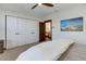 Bright bedroom featuring neutral carpet, ceiling fan, closet, and decorative art above bed at 515 S Grant St, Denver, CO 80209