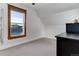Bright bedroom featuring neutral carpet, window with wood trim and a dark-toned dresser at 515 S Grant St, Denver, CO 80209