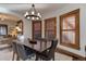 Dining room featuring a chandelier and wood-trimmed windows, with a view into the living room at 515 S Grant St, Denver, CO 80209