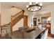 Elegant dining room with staircase, hardwood floors, and modern lighting fixture at 515 S Grant St, Denver, CO 80209