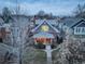 Aerial view of a charming house with inviting porch, brick facade, gray shingles, and landscaping at dusk at 515 S Grant St, Denver, CO 80209