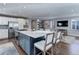 Modern, open-concept kitchen featuring a large island with seating, stainless steel appliances, and sleek cabinetry at 515 S Grant St, Denver, CO 80209