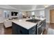 Open kitchen with a large center island, built in oven, and breakfast bar facing the living area at 515 S Grant St, Denver, CO 80209