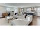 Open-concept living room features an island kitchen with a breakfast bar and pendant lighting at 515 S Grant St, Denver, CO 80209