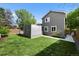 Green backyard with lawn and fenced patio with a partial privacy wall at 2667 E 132Nd Ave, Thornton, CO 80241