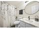 Bathroom with a shower-tub combo, granite sink, and gray and white floral shower curtain, and updated fixtures at 2667 E 132Nd Ave, Thornton, CO 80241