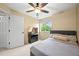 Cozy bedroom with a comfortable bed, ceiling fan, carpeted floors, and natural light from the window at 2667 E 132Nd Ave, Thornton, CO 80241